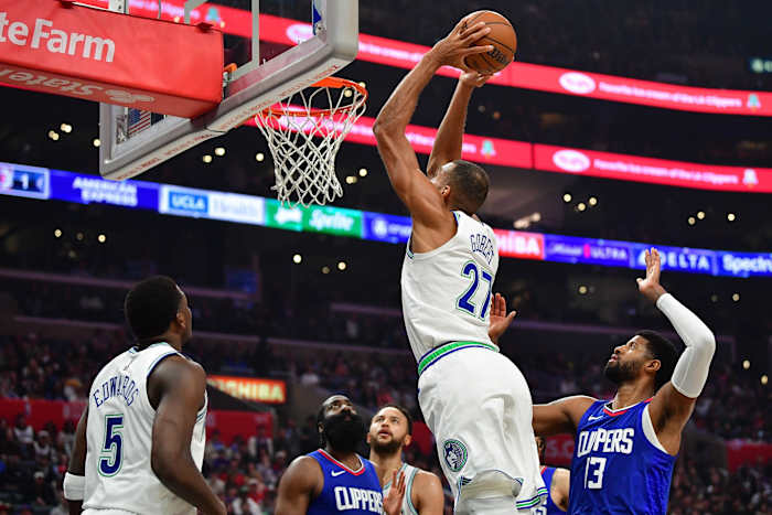 Mar 12, 2024; Los Angeles, California, USA; Minnesota Timberwolves center Rudy Gobert (27) moves in for the dunk against Los Angeles Clippers forward Paul George (13) during the first half at Crypto.com Arena.